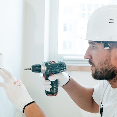Contractor using a power drill on a job site